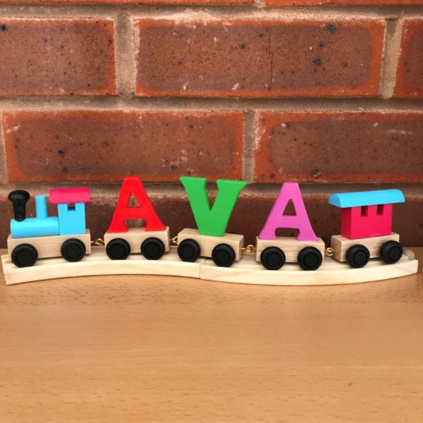 multi coloured wooden name train on track